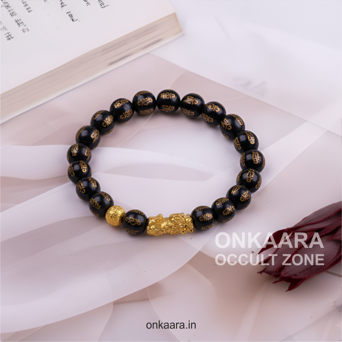 Handcrafted Pixu bracelet with red string symbolizing good fortune.