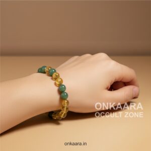 Hand wearing a Citrine and Green Aventurine crystal bracelet with round polished beads.